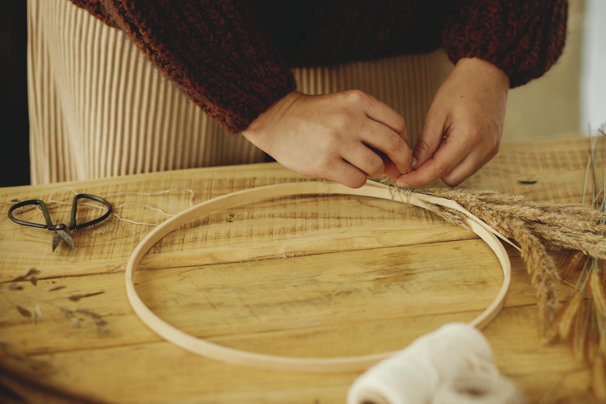 Embroiderer adjusting hoop in studio